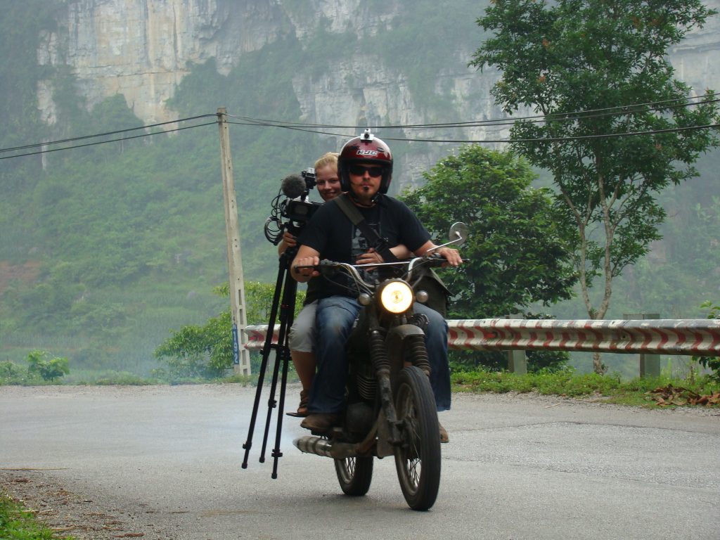 Charley Boorman riding with his camera equipment