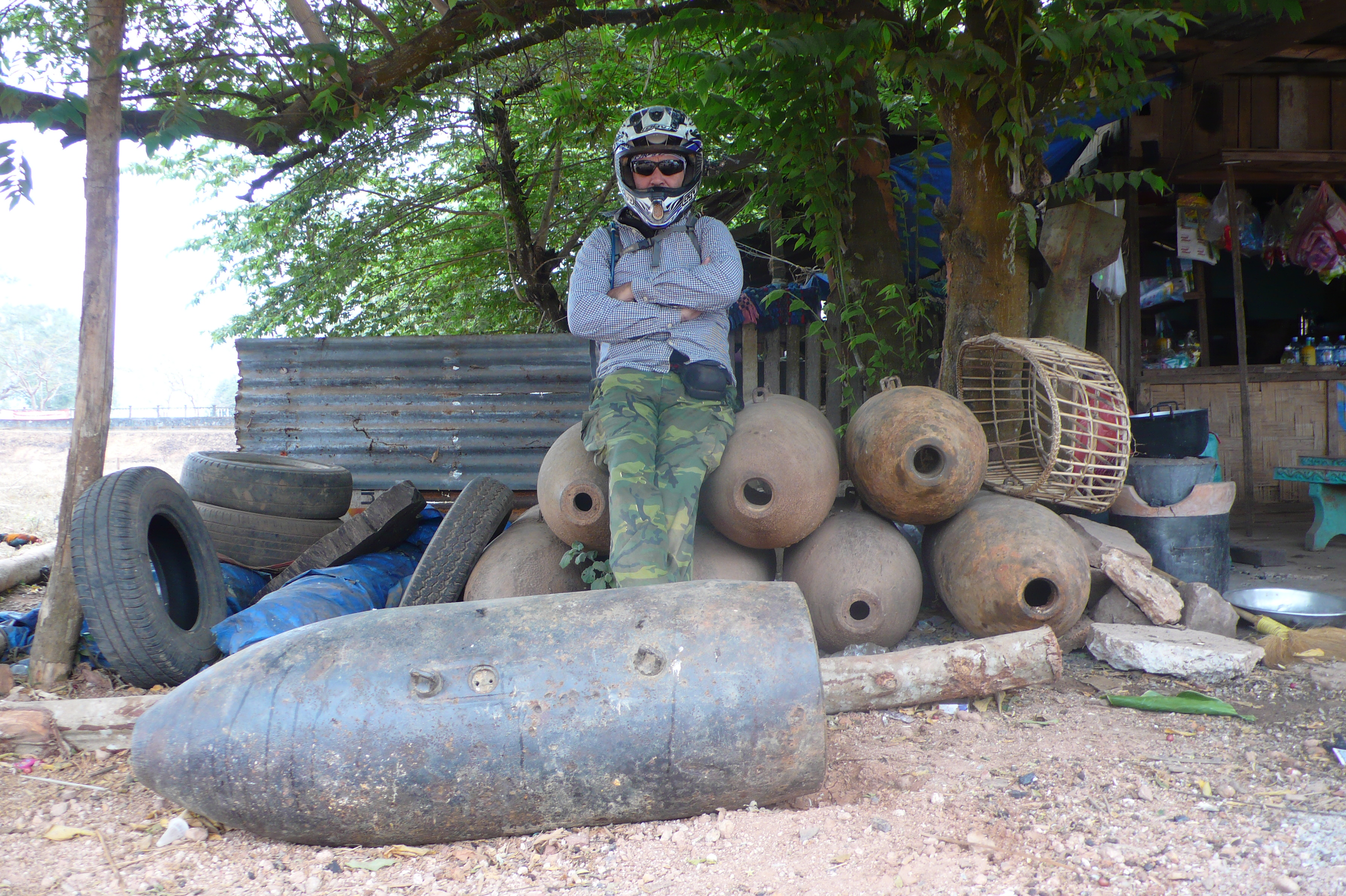 Explore Indochina rider taking a photo next to a huge bomb