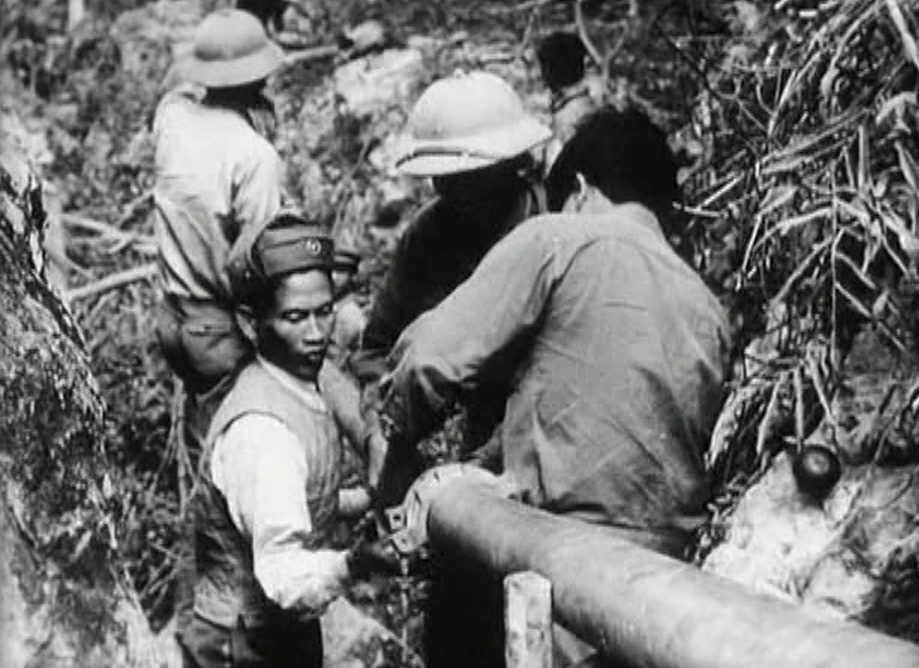 Vietnamese workers installing fuel pipes