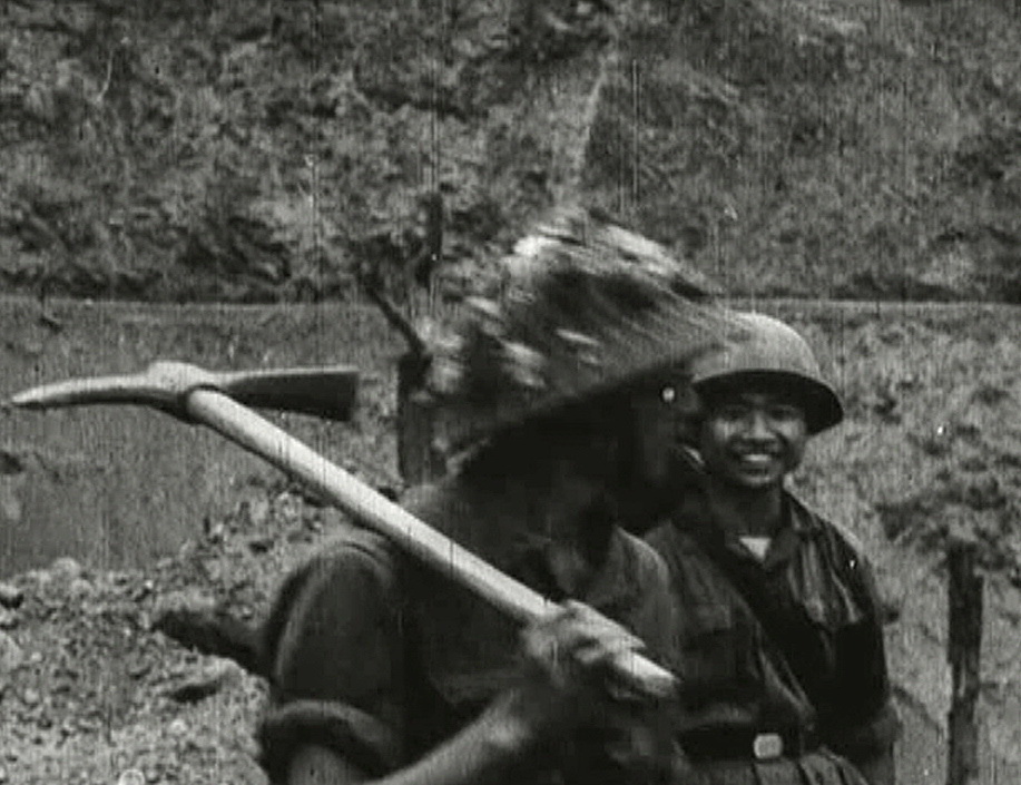 a Vietnamese soldier with a pickaxe