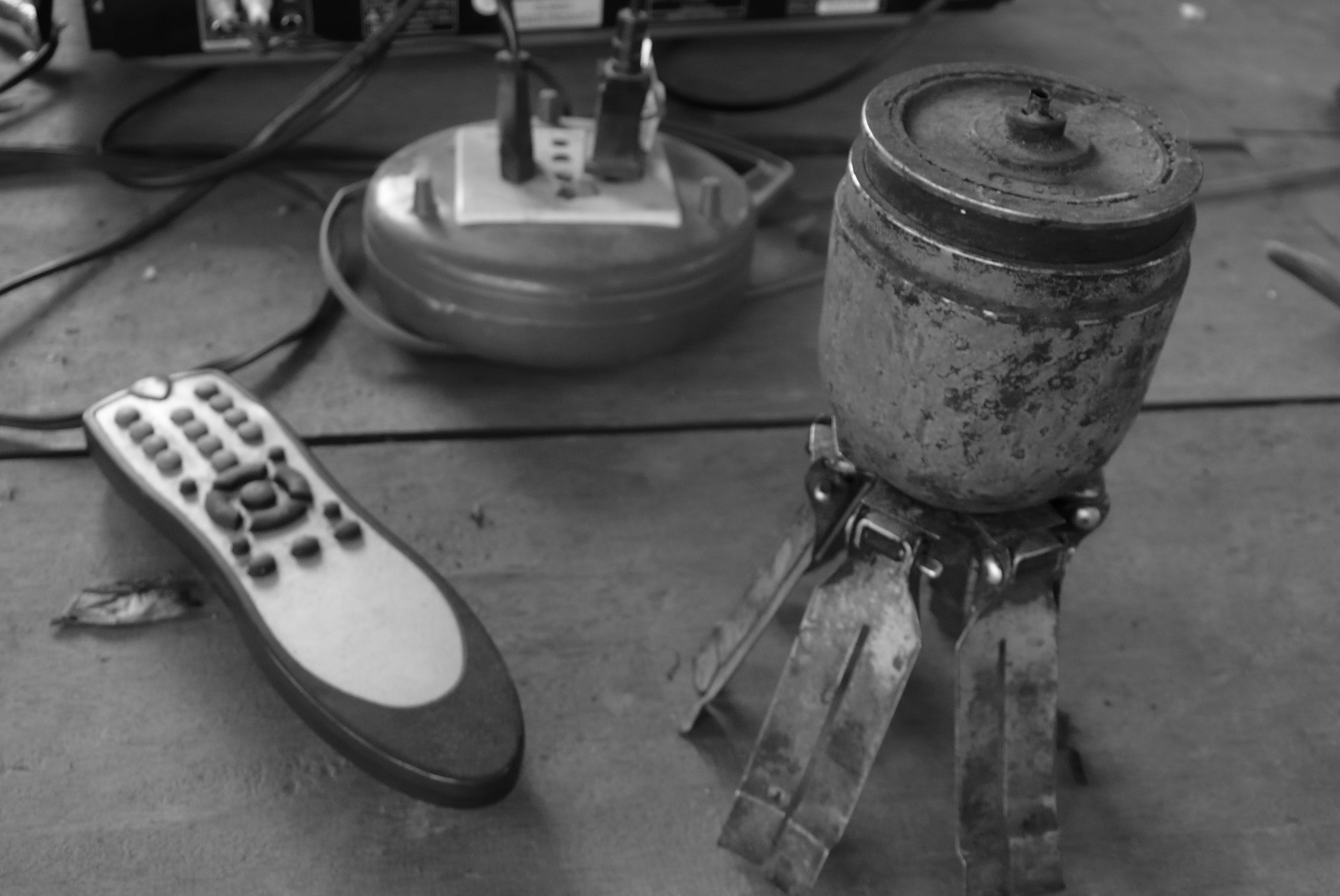 a cluster bomb being used as a lamp beside a DVD remote
