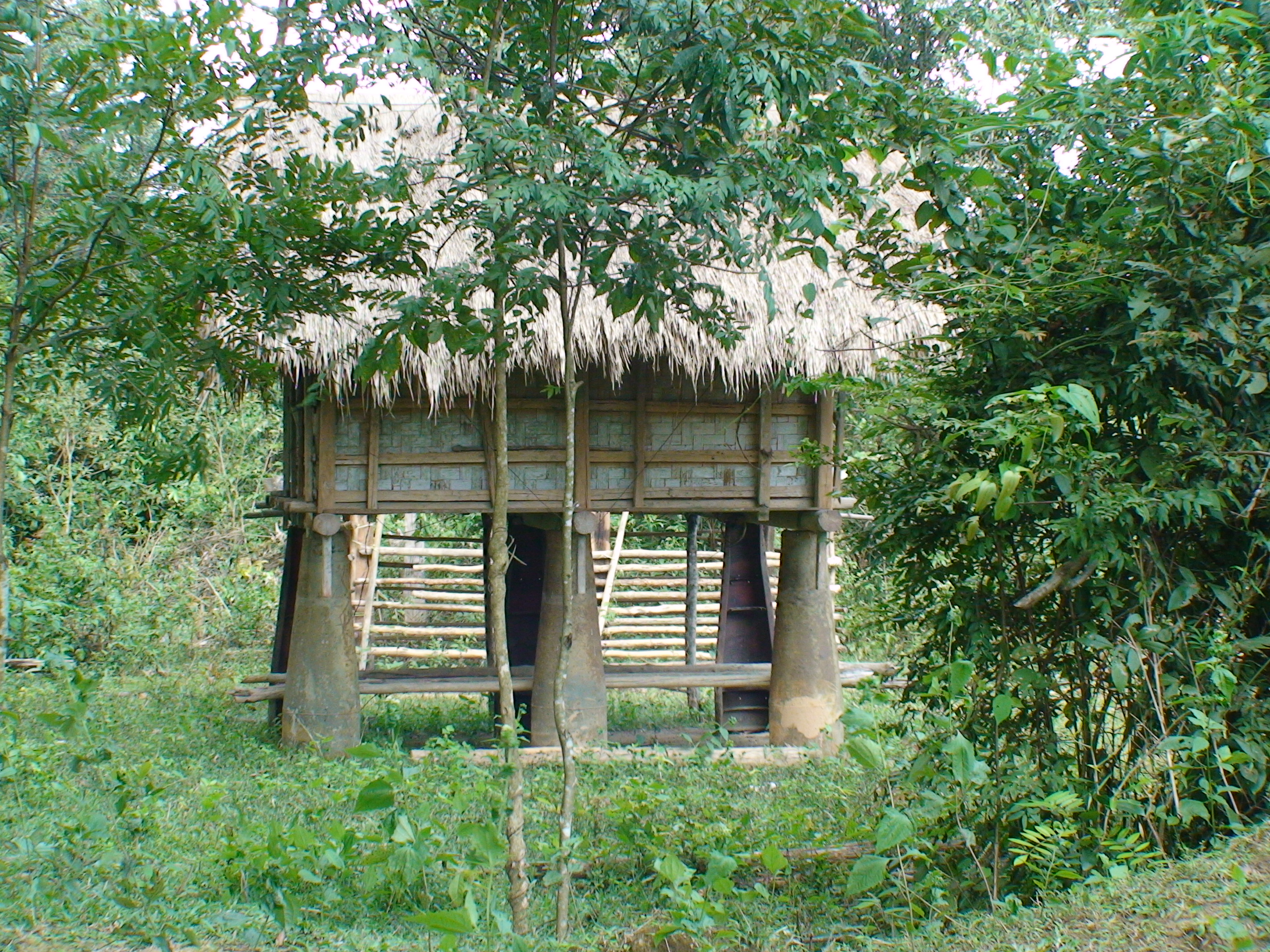 a rice storage shed being supported with bomb casings