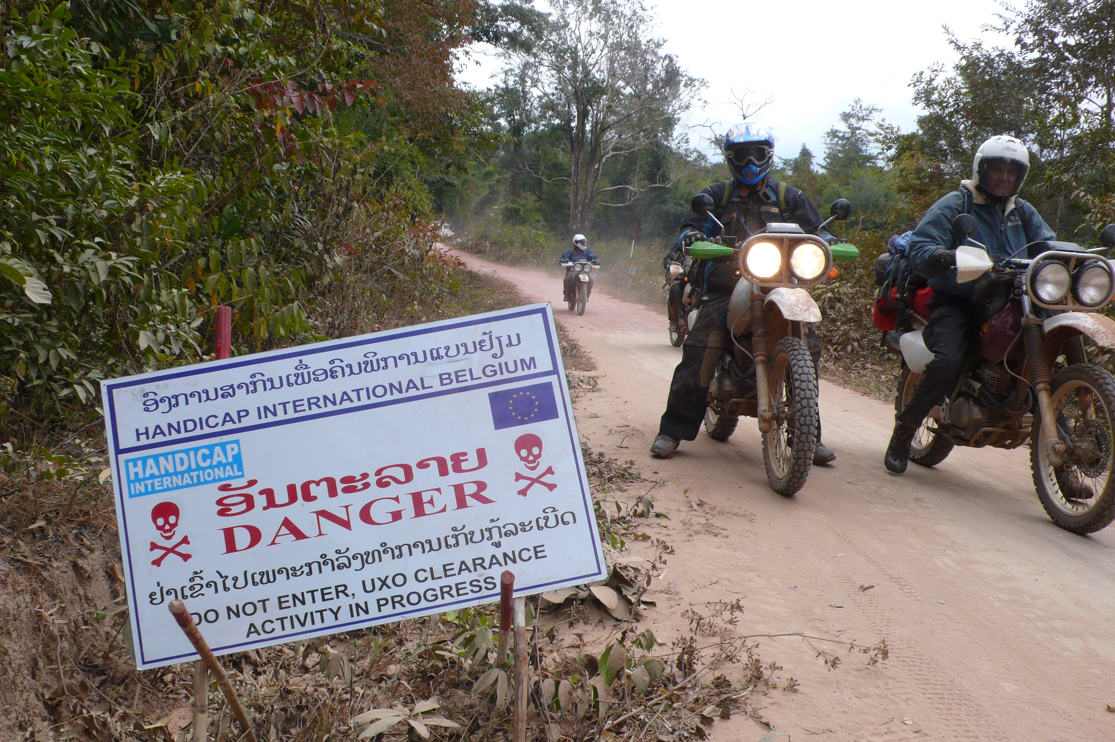 a sign in Laos warning of unexploded bombs