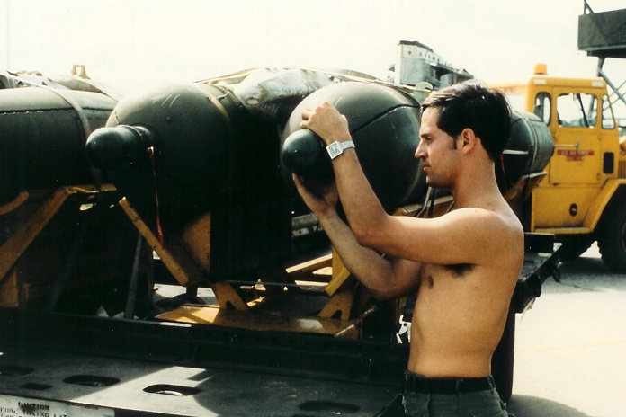 a soldier transporting cluster bombs