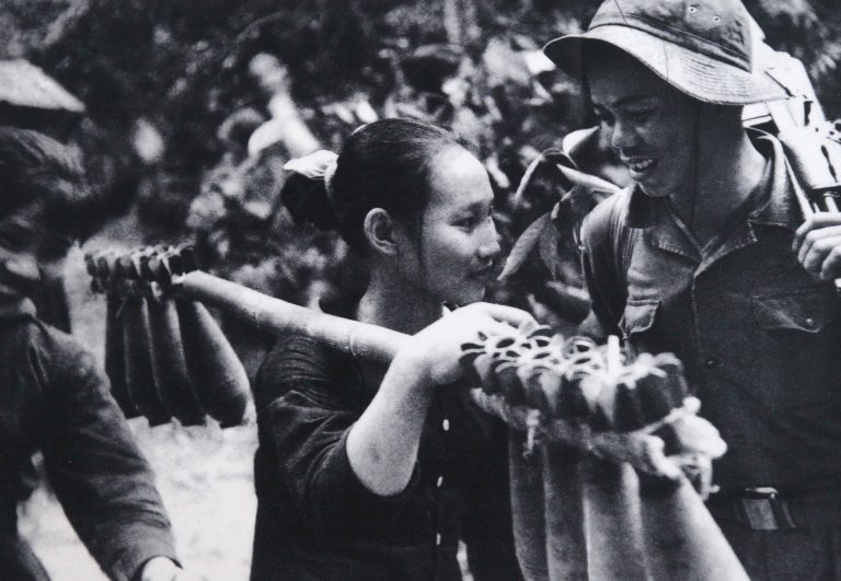 female Vietnamese soldier carrying mortars
