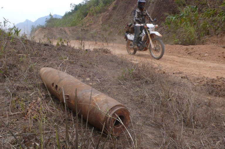 riding past a bomb on the Ho Chi Minh Trail
