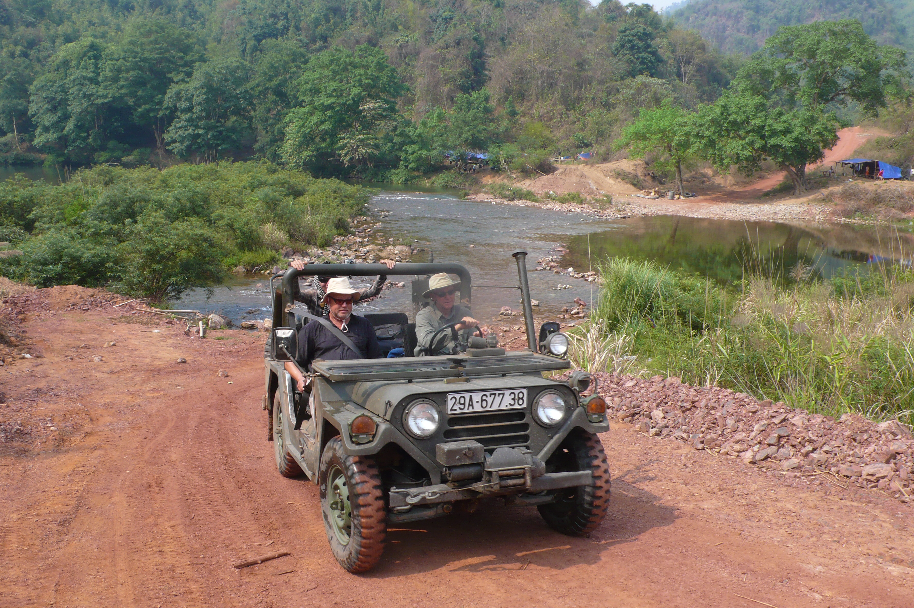 two US Vietnam veterans crossing Ban Laboy in a Jeep