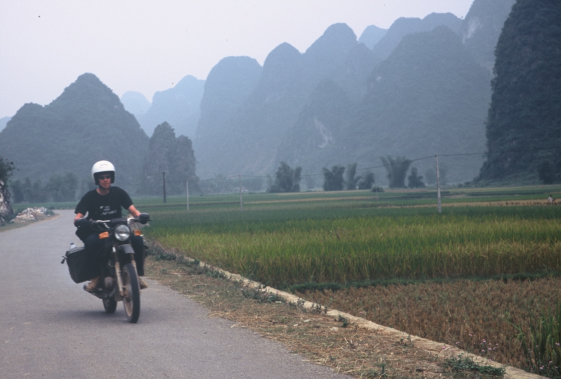 riding a Minsk motorcycle through mountainous Cao Bang
