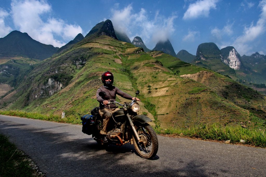 riding through the steep mountains of Ha Giang