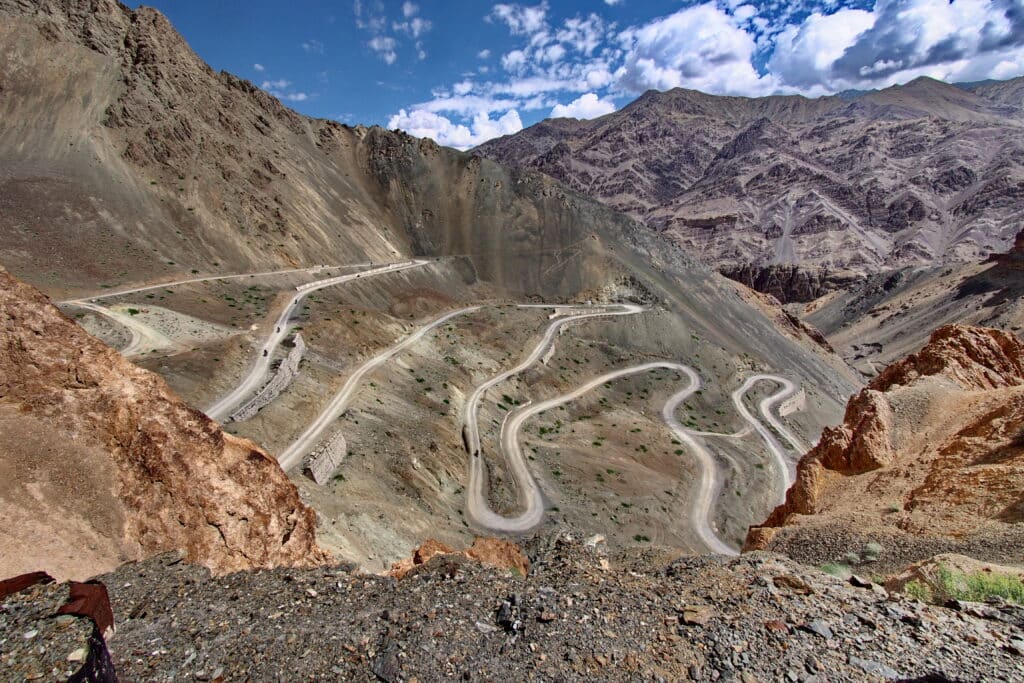 Explore Indochina riders enjoy a twisty road near Lamayuru while on a motorcycle tour of the Himalayas in India