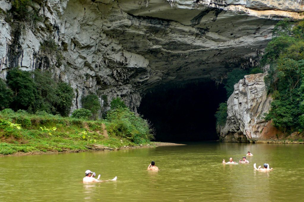 swimming by a cave in Ba Be Lake, North Vietnam