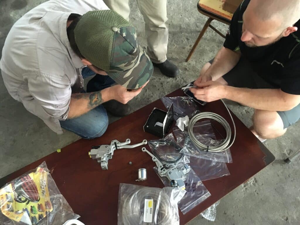 trying to figure out how to make a manual motorcycle work for someone with one arm during the filming of BBC: Without Limits