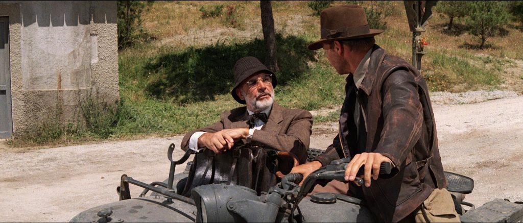 Indiana Jones and his father having an argument on an old Soviet motorcycle