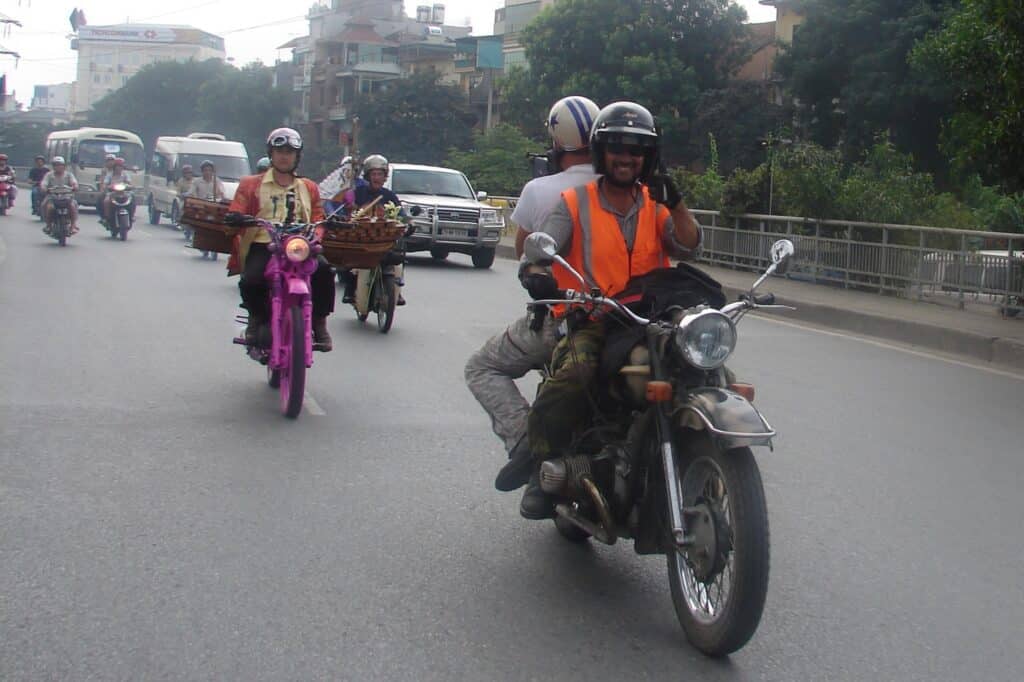 Digby Greenhalgh carries the cameraman filming Richard Hammond and James May on the streets of Hanoi for the Top Gear Vietnam Special