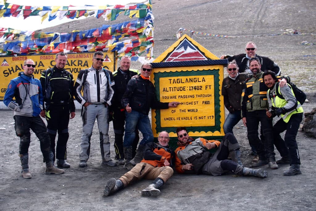 Group photo at the top of the Tag Lang La Pass while on a motorcycle tour of the Himalayas in India