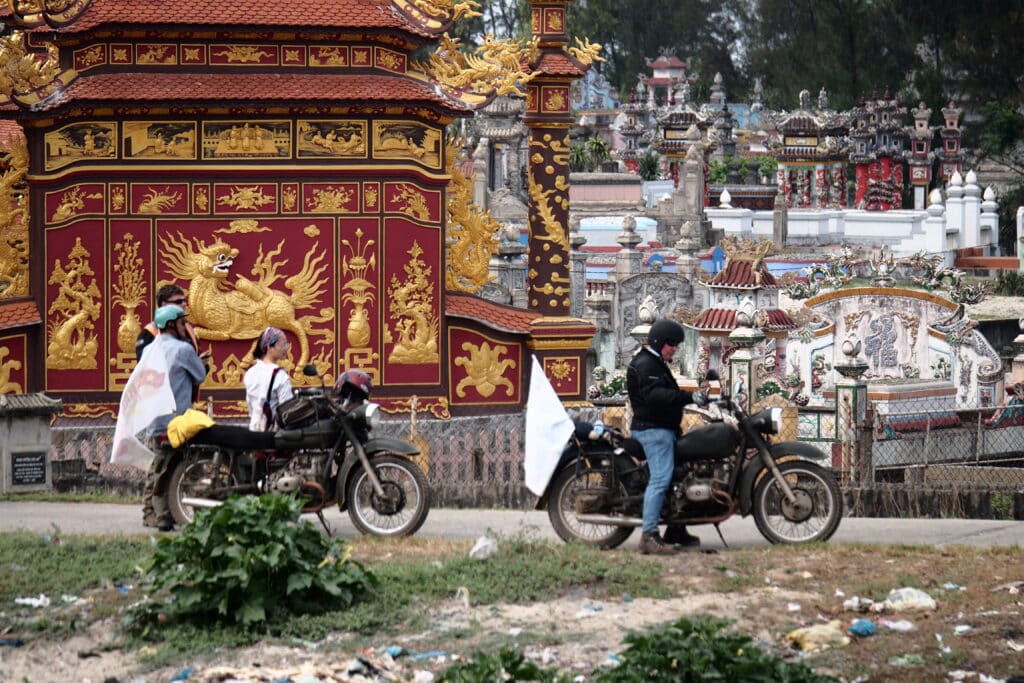 Riding past the City of the Dead in near Hue while on a motorbike tour of Vietnam