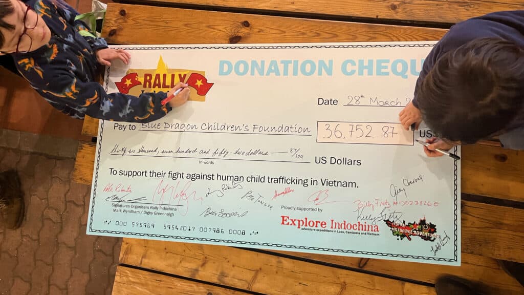Signing the cheque in 2023