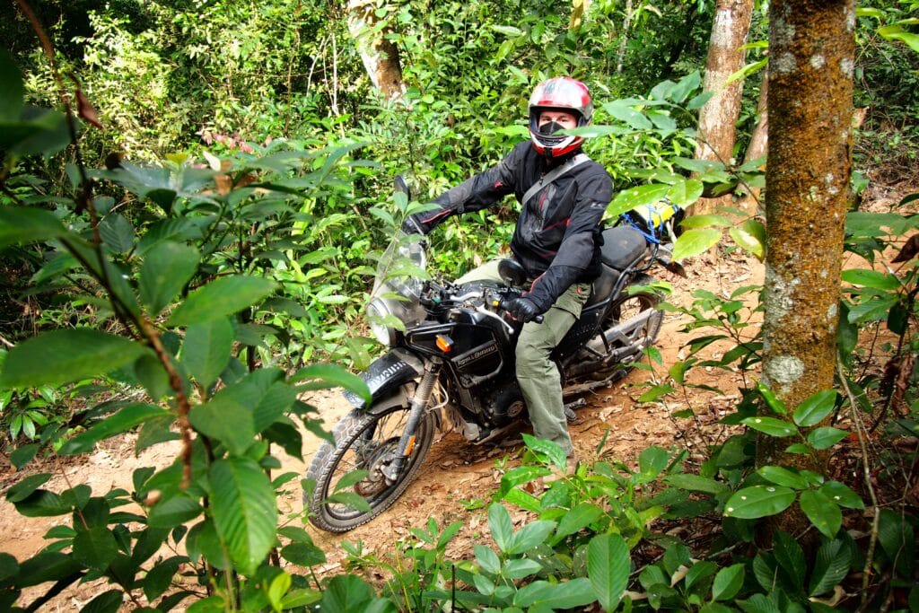 An Explore Indochina rider enjoying forest trails near Pu Luong while on Vietnam motorbike tour