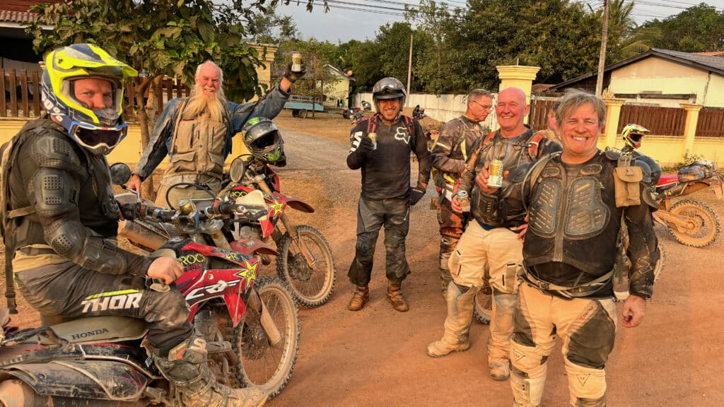 Explore Indochina riders enjoy a cold beer in Bualapha after a hard days ride down the Ho Chi Minh Trail in Laos