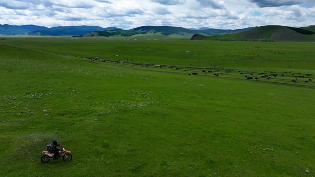 A Mongolia motorcycle tour rider heads to the Chuluut Valley