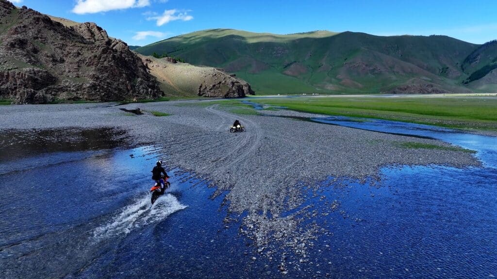 Explore Indochina riders enjoy a river crossing during their Mongolia motorbike tour
