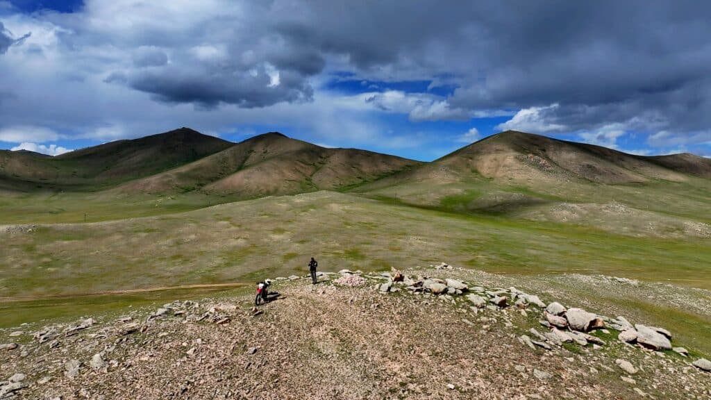 An Explore Indochina rider enjoying verdant steppes near White Lake on his Mongolia motorcycle tour