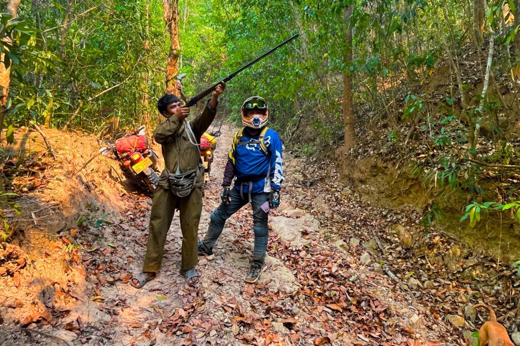 An Explore Indochina rider enjoys dirt tracks while on a motorbike tour of the Ho Chi Minh Trail in Laos